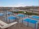 Community pickleball courts offer residents a fun, active lifestyle with mountain views in the distance at 36956 W Santa Maria St, Maricopa, AZ 85138