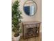 Entryway with decorative mirror, side table, bamboo plant and natural light at 3698 N 162Nd Ln, Goodyear, AZ 85395