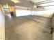 Large two car garage with white walls and cement flooring at 11546 E Kilarea Ave, Mesa, AZ 85209