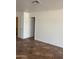 Bedroom with white walls and tiled floors, offering a bright space ready for customization and renovation at 11918 W Aster Dr, El Mirage, AZ 85335