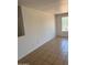 Bedroom with large window providing natural light, and tiled flooring, ready for renovation and personalization at 11918 W Aster Dr, El Mirage, AZ 85335