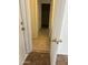 Hallway with tile flooring, leading to room with carpeting at 11918 W Aster Dr, El Mirage, AZ 85335