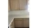 Kitchen featuring light wood cabinets and white countertops at 11918 W Aster Dr, El Mirage, AZ 85335
