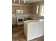 Kitchen with light wood cabinets, white appliances, and tile flooring at 11918 W Aster Dr, El Mirage, AZ 85335
