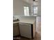 Kitchen with stainless steel sink, light wood cabinets, and breakfast bar overlooking the living area at 11918 W Aster Dr, El Mirage, AZ 85335
