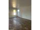 A bright living room with tiled floors, white walls, and large windows with natural light at 11918 W Aster Dr, El Mirage, AZ 85335