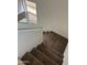 Carpeted staircase with white walls and natural light at 11918 W Aster Dr, El Mirage, AZ 85335
