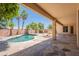 This backyard features a covered patio, stone floors, and a swimming pool at 2620 W Piedmont Rd, Phoenix, AZ 85041