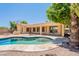 Backyard features a sparkling pool with a stone patio, barbecue area and lush greenery at 2620 W Piedmont Rd, Phoenix, AZ 85041