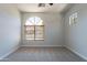 This bedroom features neutral carpet, large windows, and lots of light at 2620 W Piedmont Rd, Phoenix, AZ 85041