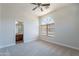 This bedroom features neutral carpet, an ensuite bathroom, and lots of light at 2620 W Piedmont Rd, Phoenix, AZ 85041