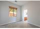 This bedroom features neutral carpet and a view into the bathroom at 2620 W Piedmont Rd, Phoenix, AZ 85041