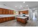 Bright kitchen with stainless steel appliances, spacious island, and wood cabinetry at 2620 W Piedmont Rd, Phoenix, AZ 85041