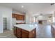 Open concept kitchen with wood cabinets, a marble island, and connection to the living area at 2620 W Piedmont Rd, Phoenix, AZ 85041