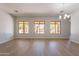 Bright open-concept living area with hardwood floors and backyard views through the large windows at 2620 W Piedmont Rd, Phoenix, AZ 85041