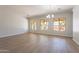 Light-filled living room with hardwood floors and large windows offering backyard views at 2620 W Piedmont Rd, Phoenix, AZ 85041