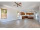 Open-concept living room with wood-look floors, large windows, and kitchen view at 2620 W Piedmont Rd, Phoenix, AZ 85041