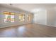 Large open living room with hardwood floors and multiple windows overlooking the backyard pool at 2620 W Piedmont Rd, Phoenix, AZ 85041