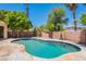 Inviting pool area features a beautiful stone patio and lush landscaping, perfect for relaxation and entertainment at 2620 W Piedmont Rd, Phoenix, AZ 85041
