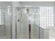 Bright bathroom featuring a walk-in shower with chrome fixtures, glass block window and tile flooring at 2620 W Piedmont Rd, Phoenix, AZ 85041