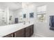 Bright bathroom with a large mirror, dual sinks, and a window for natural light at 2640 N Heritage St, Buckeye, AZ 85396