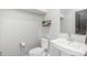 Powder room with white fixtures, pedestal sink, and decorative shelf at 2640 N Heritage St, Buckeye, AZ 85396