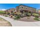 Charming townhome featuring a covered porch, desert landscaping, and a well-maintained walkway at 2640 N Heritage St, Buckeye, AZ 85396