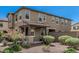 Beautiful townhome exterior showcasing desert landscaping, a covered porch, and well-maintained stucco at 2640 N Heritage St, Buckeye, AZ 85396