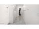 Well-lit hallway with access to the shower, closet, and other rooms with light tile floors at 2640 N Heritage St, Buckeye, AZ 85396