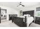 Comfortable main bedroom with a striking black headboard, neutral carpet, and convenient ensuite bathroom and walk-in closet at 2640 N Heritage St, Buckeye, AZ 85396