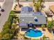 An aerial view shows a home with solar panels on the roof and a backyard featuring a sparkling blue swimming pool at 3538 W Willow Ave, Phoenix, AZ 85029