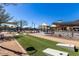 Community space with cornhole, playground and outdoor lounge area at 4060 E French Trotter St, San Tan Valley, AZ 85140