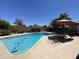Refreshing backyard pool with patio furniture and beautifully landscaped surroundings at 534 E Pebble Beach Dr, Tempe, AZ 85282