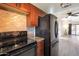 Beautiful kitchen boasting granite countertops, updated cabinets, and black appliances at 600 S Dobson Rd # 67, Mesa, AZ 85202