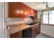 Modern kitchen features stainless steel appliances, granite countertops, tile backsplash, and dark cabinetry at 600 S Dobson Rd # 67, Mesa, AZ 85202