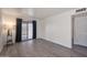 An airy living room featuring sleek, grey, wood-look flooring, a sliding glass door to the patio, and neutral walls at 600 S Dobson Rd # 67, Mesa, AZ 85202