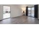 A welcoming living room with modern gray flooring and views of the front door and fenced-in patio area at 600 S Dobson Rd # 67, Mesa, AZ 85202