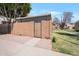 Enclosed side yard featuring block fencing, a wooden access gate, and a gravel landscape at 600 S Dobson Rd # 67, Mesa, AZ 85202