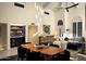Open concept dining room, bar, and living room with high ceilings and modern lighting at 8332 E San Simon Dr, Scottsdale, AZ 85258
