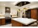 Modern kitchen with stainless steel appliances, mosaic tile backsplash, and an island with seating at 8332 E San Simon Dr, Scottsdale, AZ 85258