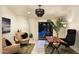 Bright living room featuring a modern chandelier, stylish seating, and seamless access to the outdoor pool at 8332 E San Simon Dr, Scottsdale, AZ 85258