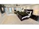 Spacious main bedroom with a tray ceiling, ensuite bathroom, and a cozy chaise lounge at 8332 E San Simon Dr, Scottsdale, AZ 85258