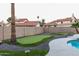 Backyard with small putt-putt golf area and pool, set among neighborhood homes at 10266 E Caron St, Scottsdale, AZ 85258
