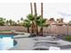 Lounge chairs sit poolside with palm trees surrounding the backyard at 10266 E Caron St, Scottsdale, AZ 85258