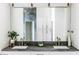 Stylish bathroom featuring double sinks, a modern vanity, and a large mirror at 10266 E Caron St, Scottsdale, AZ 85258