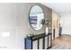A modern entryway boasts a stylish console table and contemporary mirror at 10266 E Caron St, Scottsdale, AZ 85258
