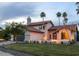 Charming pink two-story home with a tile roof, landscaped yard, and picturesque palm trees at 10266 E Caron St, Scottsdale, AZ 85258