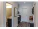 Bright hallway featuring wood floors, a decorative mirror, and neutral walls at 10266 E Caron St, Scottsdale, AZ 85258