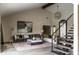 Bright living room with vaulted ceilings, modern staircase, stylish decor, and comfortable seating at 10266 E Caron St, Scottsdale, AZ 85258