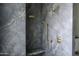 Stunning walk-in shower with gray marble-style tile and bronze fixtures at 10266 E Caron St, Scottsdale, AZ 85258